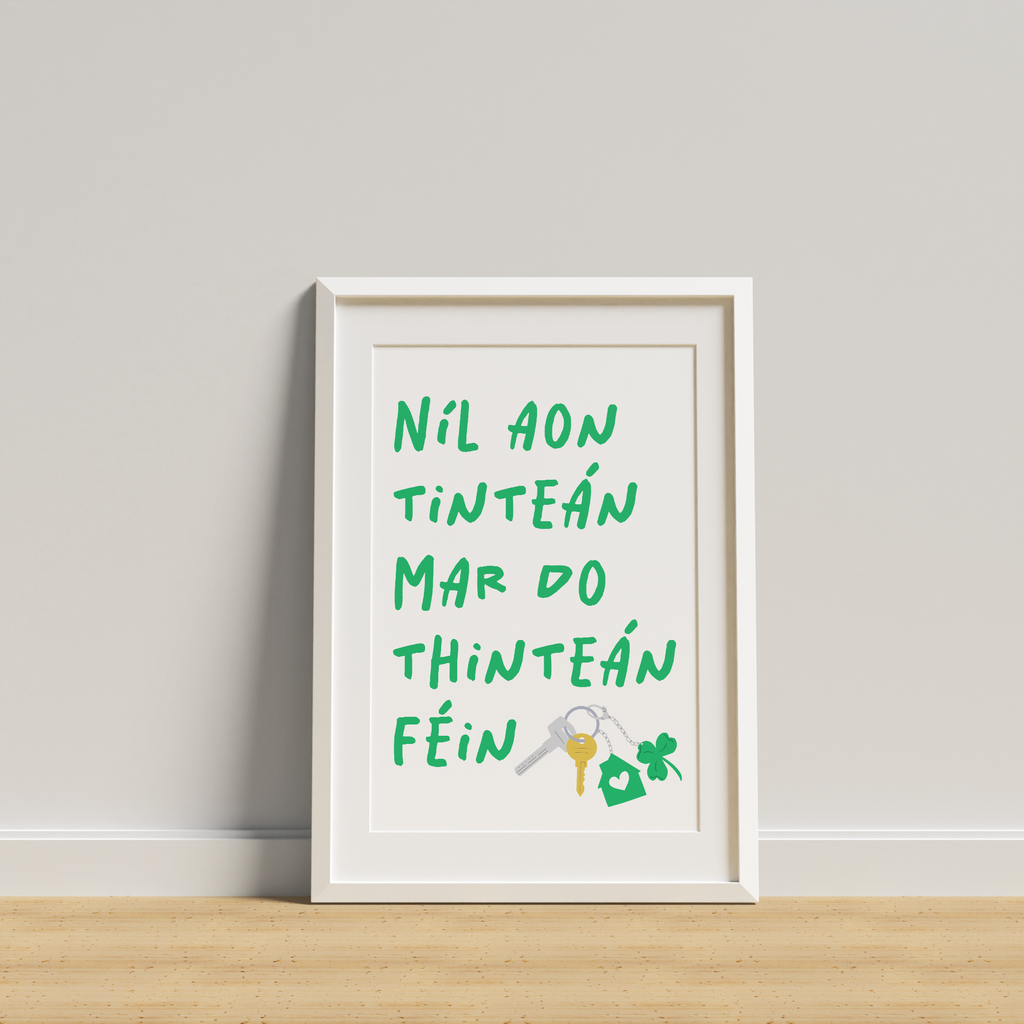 Framed artwork with text and a key symbol on a white wall.